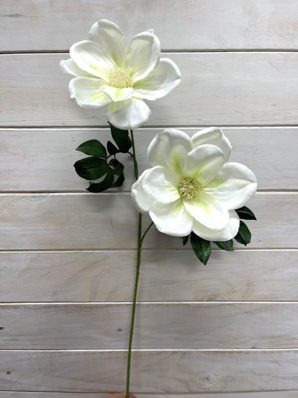 Cream artificial magnolia spray featuring two lifelike flowers, perfect for elegant home decor and low-maintenance styling.