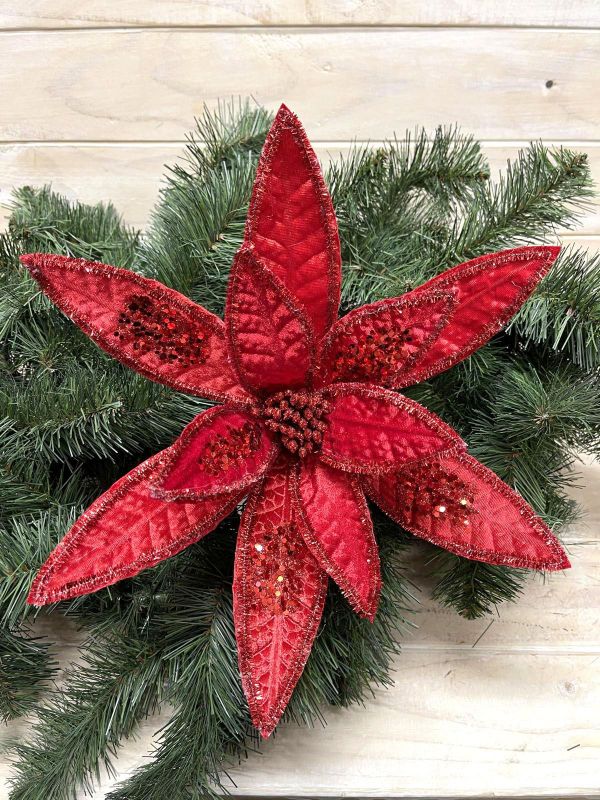 Bright red artificial poinsettia with long petals, perfect for holiday decor and festive celebrations.