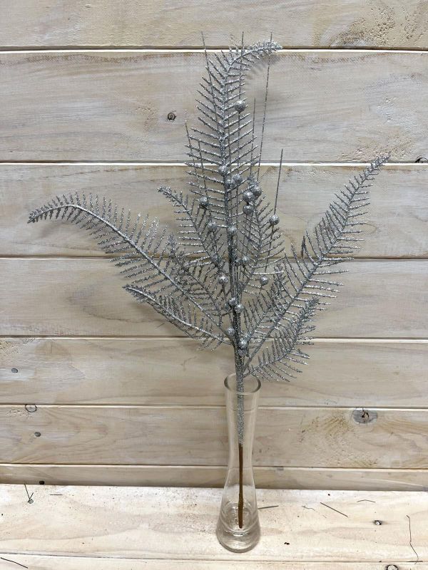 Artificial silver glittered fern spray, perfect for elegant floral arrangements and enhancing home decor.