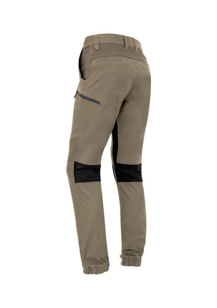 Men's khaki stretch pants by Syzmik featuring 4-way stretch, multiple pockets, and a modern slim fit for work and casual wear.