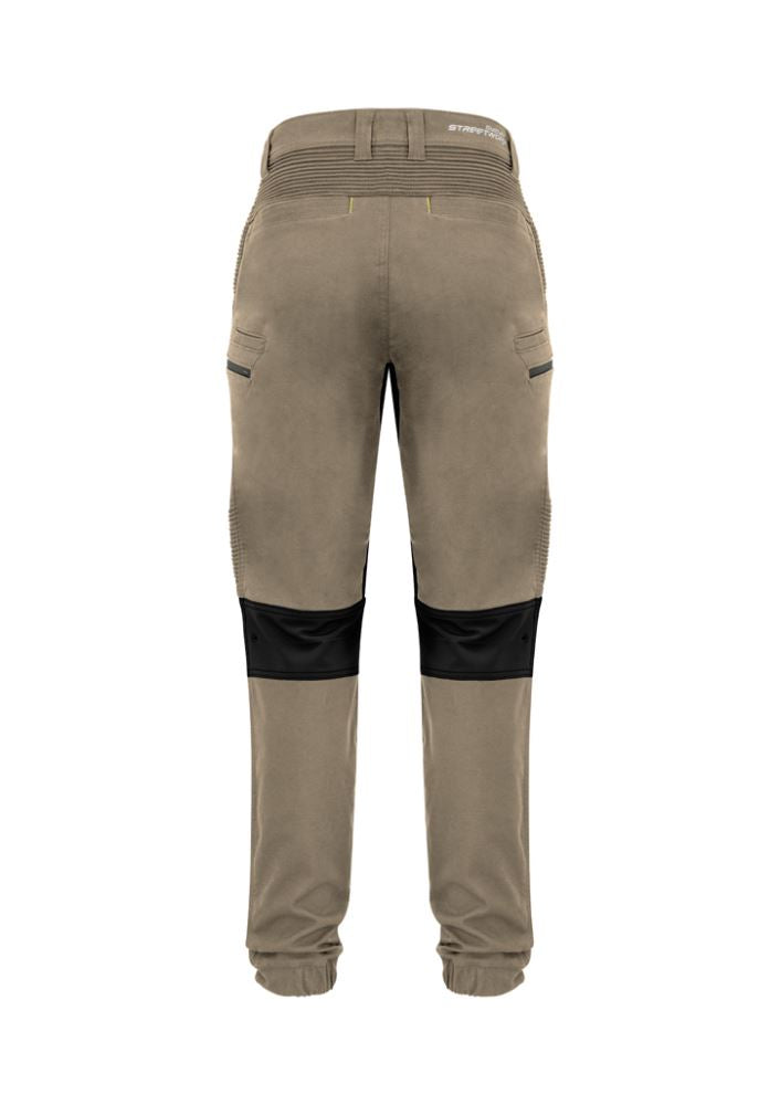 Men's khaki stretch pants from Syzmik featuring 4-way stretch, multiple pockets, and a modern slim fit for work and casual wear.