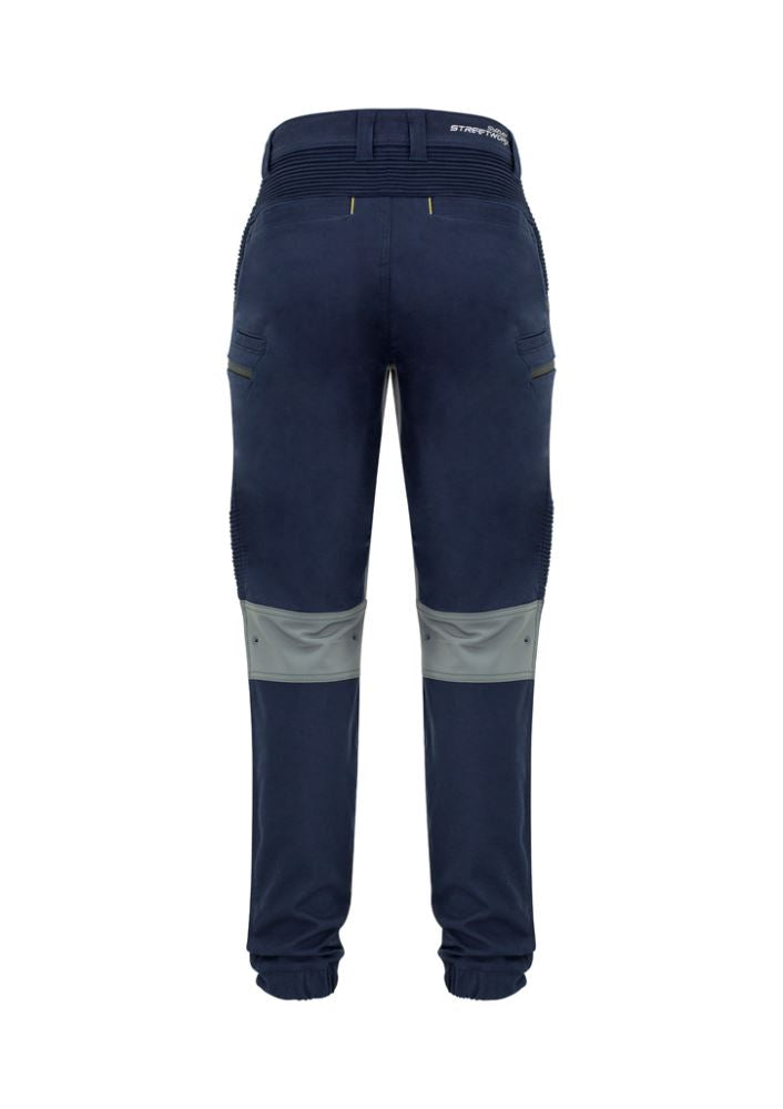Men's navy stretch pants by Syzmik featuring 4-way stretch, slim fit, large zip pockets, and reinforced details for comfort and functionality.