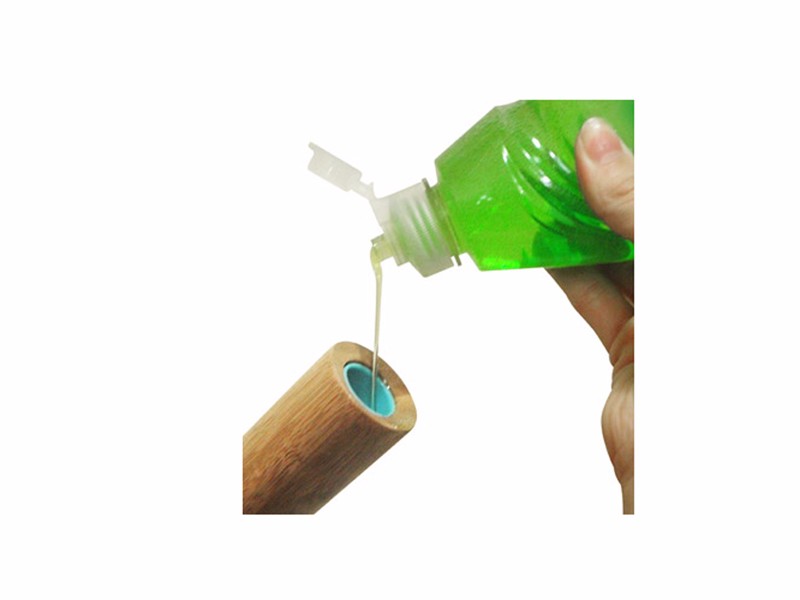 Eco-friendly SudsUp Dish Brush with a bamboo handle, designed for efficient dishwashing and sustainable living.