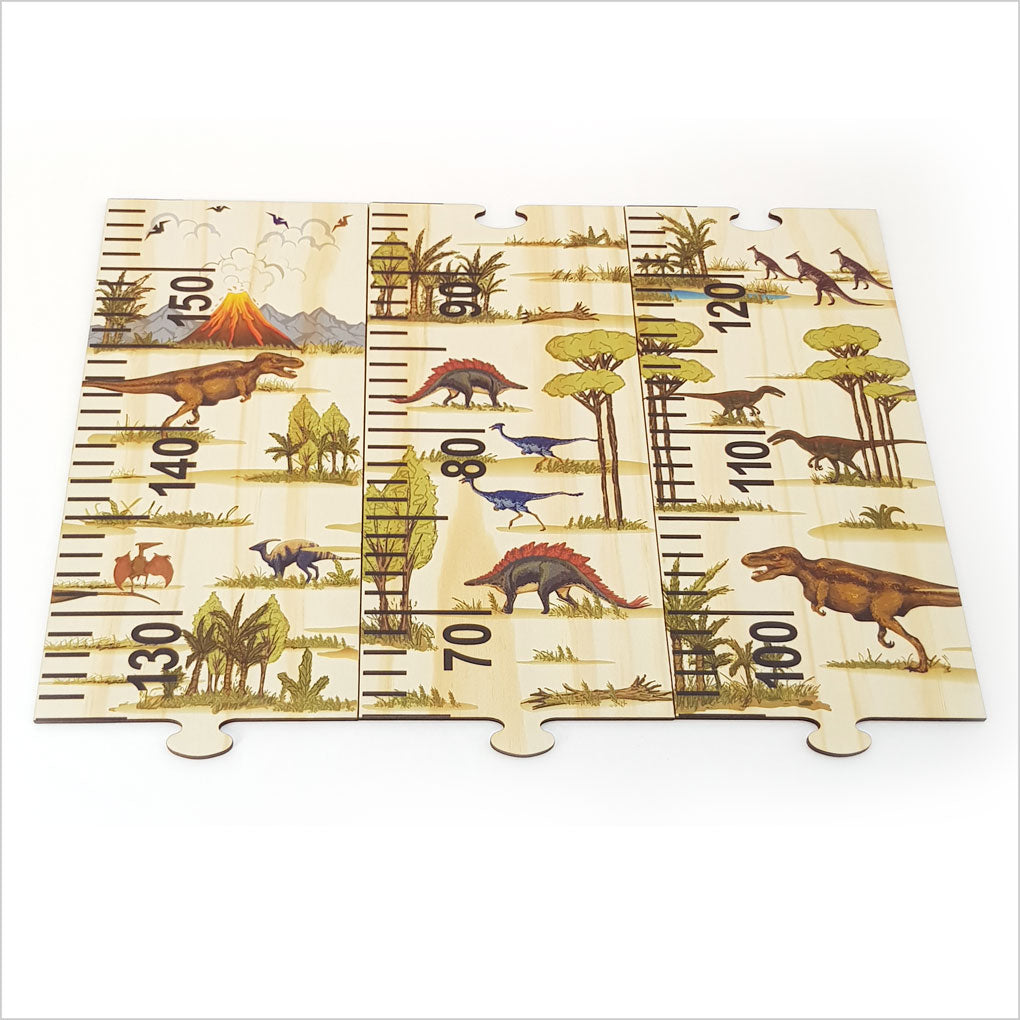 Colorful dinosaur-themed growth chart ruler in eco-friendly pine, featuring height tracking and five fun puzzle pieces for kids.