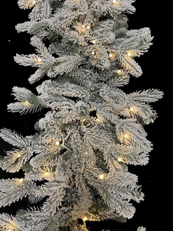 200 cm snowy Christmas garland with 324 tips and warm LED lights, perfect for festive decorating and creating a cozy atmosphere.