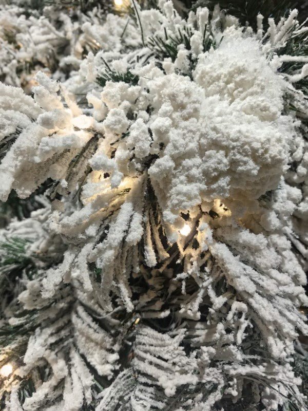8' Heavy Snow Slim Pine Tree with 600 warm white LED lights, perfect for cozy holiday decor and smaller spaces.