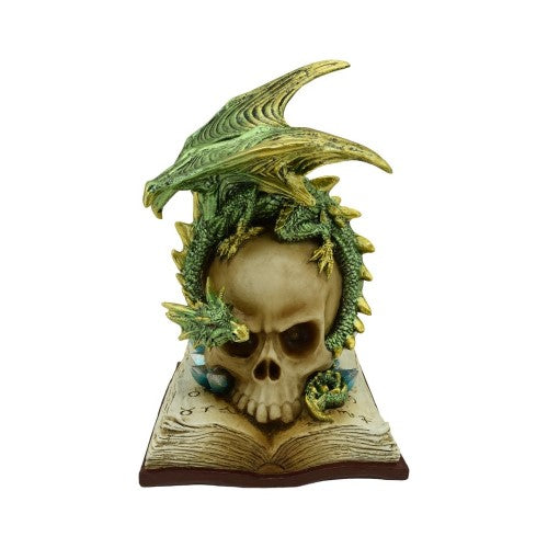 Ornament featuring a green dragon atop a skull on a book, with illuminated eyes for mystical decor appeal.