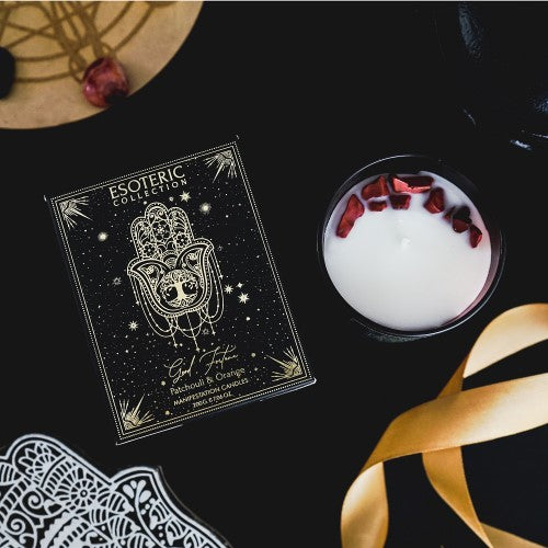 Good Fortune Patchouli & Orange Manifestation Candle in sleek black jar with gemstone chips, offers uplifting aromas and a 20-hour burn.