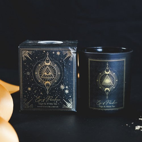 Eye of Providence candle in black frosted glass features sage and white tea scent, gemstone chips, and 20-hour burn time.