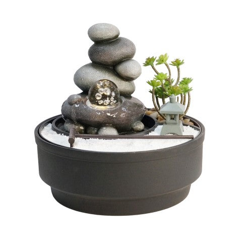 Indoor pebble fountain and sand garden with color-changing light, measuring 21 cm, made from durable polyresin.