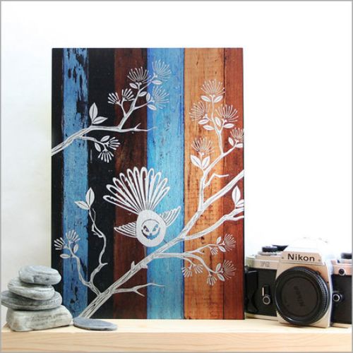 Kiwiana wall art featuring a fantail on aged timber background, printed on durable ACM, perfect for any space.
