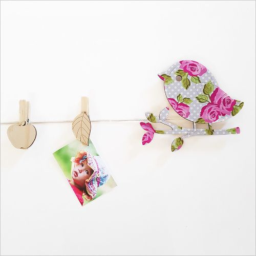 Colorful bird-shaped pegs for hanging kids' art and photos, perfect for personalized decor in children's rooms.
