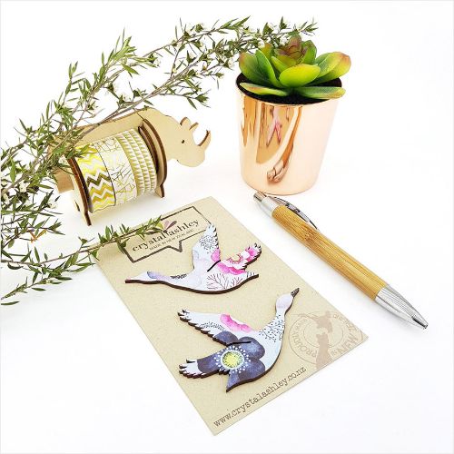 Whimsical wall art featuring ducks against a vibrant blue floral backdrop, perfect for colorful home decor.