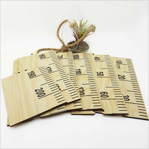 Eco-friendly growth chart ruler in pine veneer with 7 puzzle pieces, measuring 2m for marking child's growth milestones.