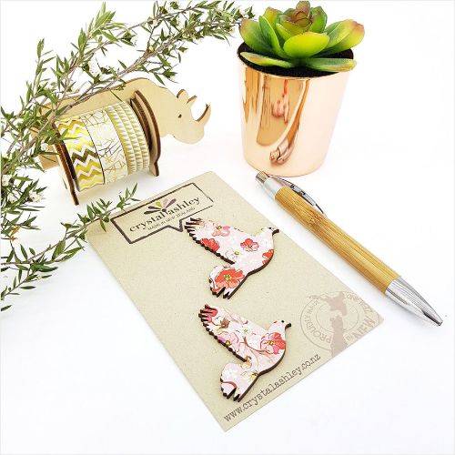 Elegant wall art featuring pink floral designs and charming pigeons, perfect for enhancing any room's decor.