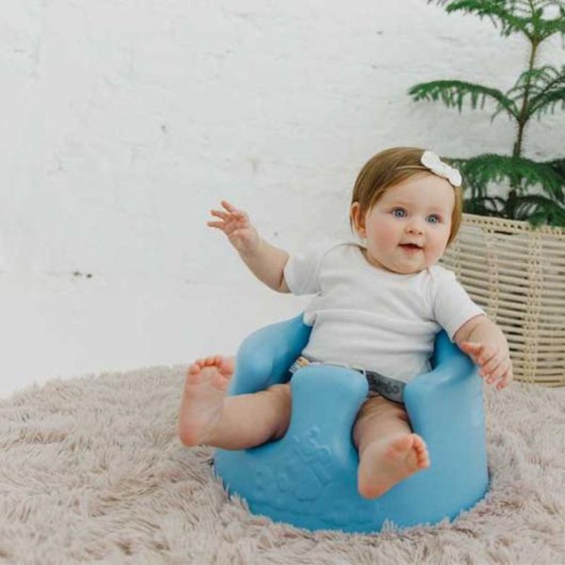 Bumbo Floor Seat in Powder Blue providing ergonomic support for babies 3-12 months as they learn to sit independently.