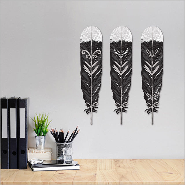 ACM wall art featuring three printed Huia feathers, celebrating New Zealand's heritage, suitable for indoor and sheltered outdoor display.