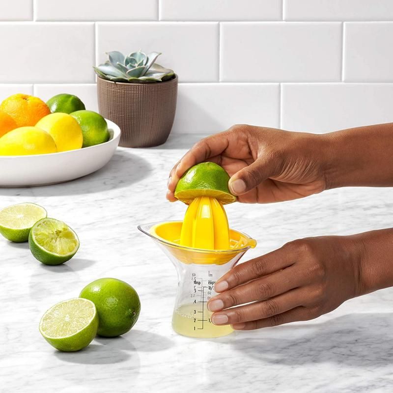Compact OXO Good Grips Small Citrus Juicer with 2.5 oz cup, drip-free spout, and efficient reamer design for easy juicing.