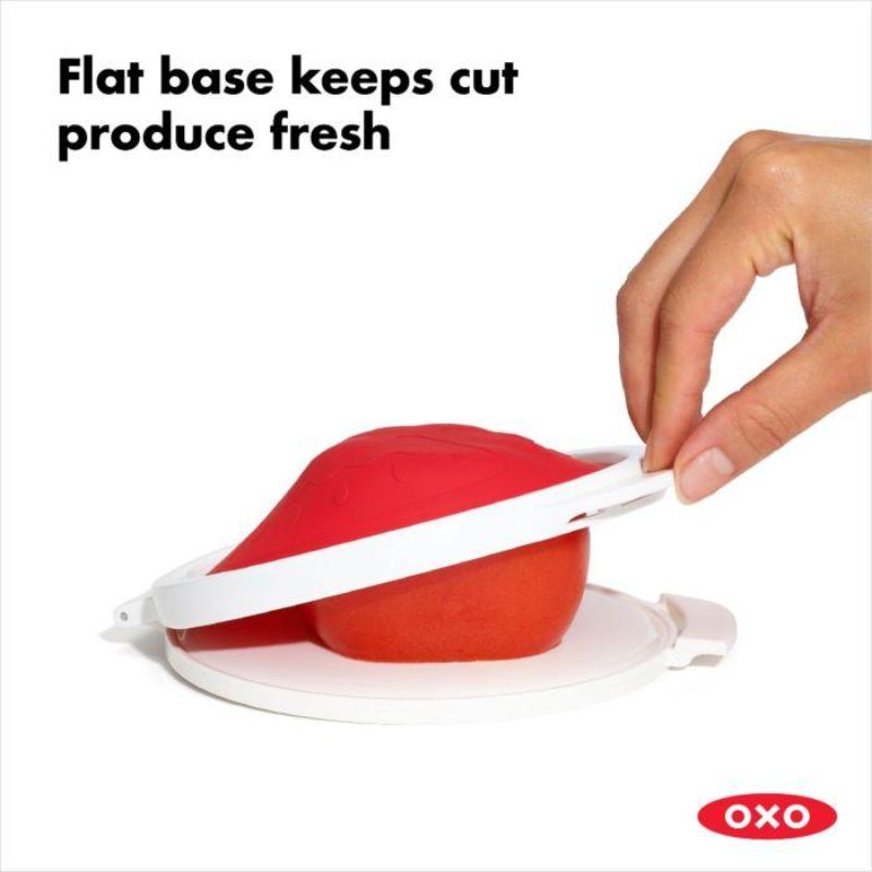 Silicone tomato saver with a hinged lid, designed to keep cut tomatoes fresh and reduce plastic waste in the kitchen.