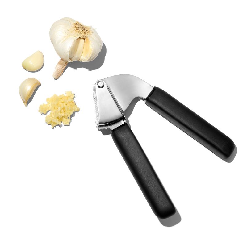 Ergonomic stainless steel garlic press with a large hopper for effortless crushing and easy cleanup, perfect for any kitchen.
