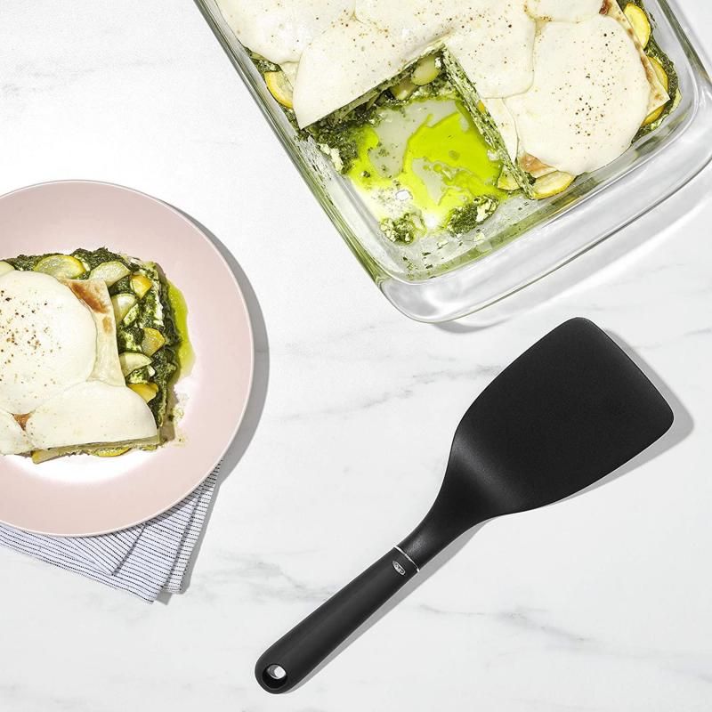 Broad nylon turner with angled neck for easy lasagna serving, heat-resistant and safe for non-stick cookware.