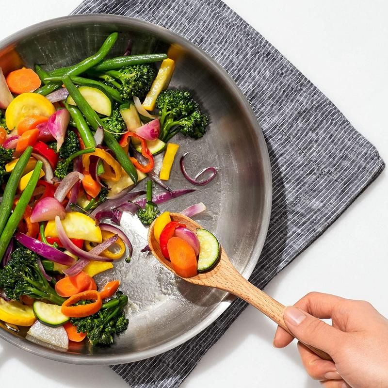 Small OXO Good Grips wooden spoon made of beech wood, featuring a comfortable handle, safe for non-stick cookware.