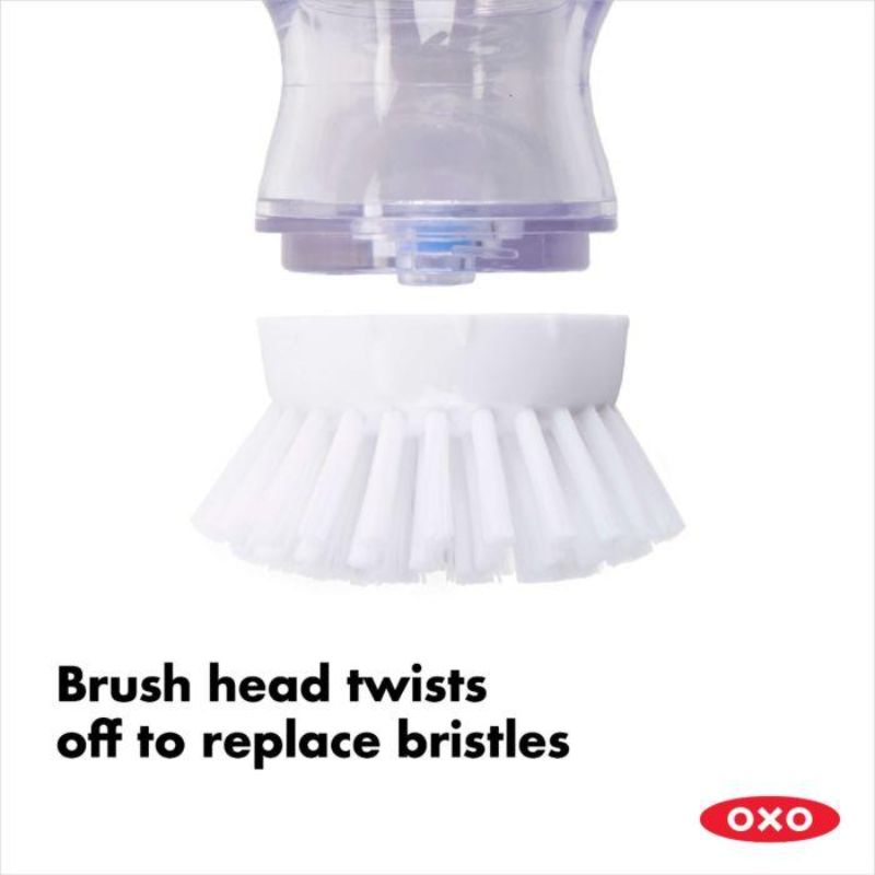 OXO Good Grips Soap Dispensing Palm Brush with ergonomic grip and durable bristles, dispenses soap for easy cleaning.