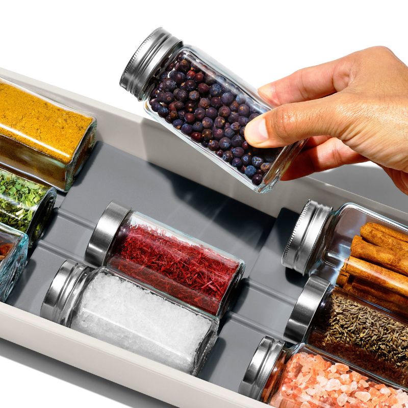 Tiered spice drawer organizer with non-slip feet, keeping spices neat and visible in a space-saving design.