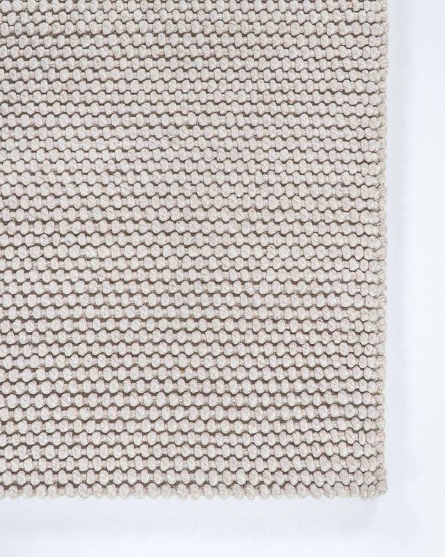 Handwoven silver floor rug measuring 160x230cm, featuring a textured knot-style weave for comfort and elegance.