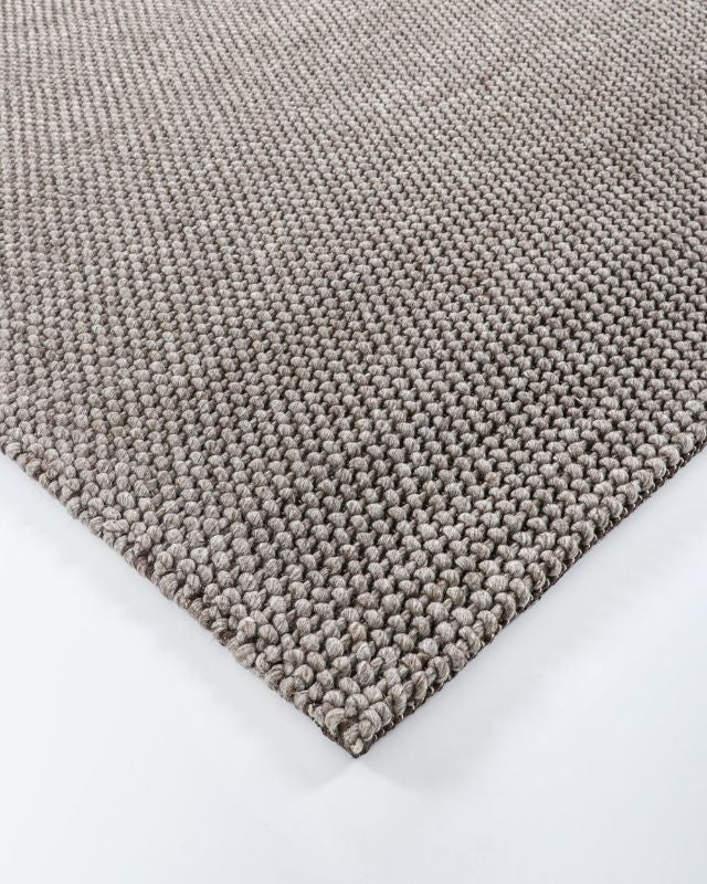 Handwoven silver floor rug measuring 160x230cm, featuring a textured knot-style weave for comfort and elegance.