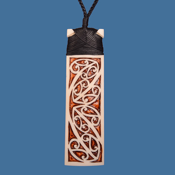 Maori Kowhaiwhai Design Stained Bone Toki Pendant, intricately carved, 100mm tall, on adjustable black wax cord.