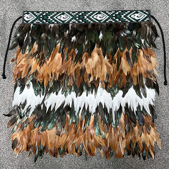 Handmade Korowai Tamariki - Ruru featuring vibrant feathers and taniko trim, embodying Maori culture and wisdom.