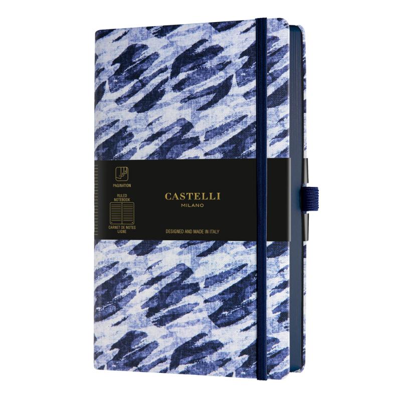 Elegant A5 Castelli Notebook with Shibori blue patterns, ruled ivory pages, ribbon marker, and eco-friendly features.