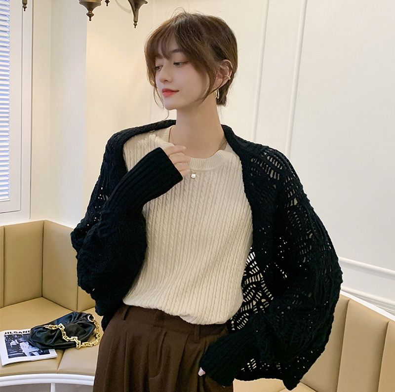 Black Joanna Crochet Shrug made of 100% cotton, featuring intricate design, perfect for layering with any outfit.