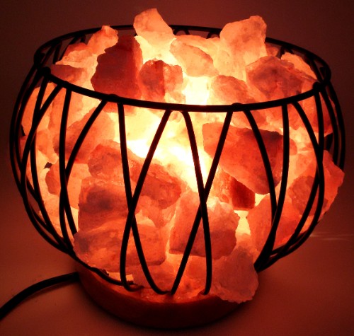Himalayan salt lamp in a stylish metal cage, enhancing decor and purifying air with a warm glow.
