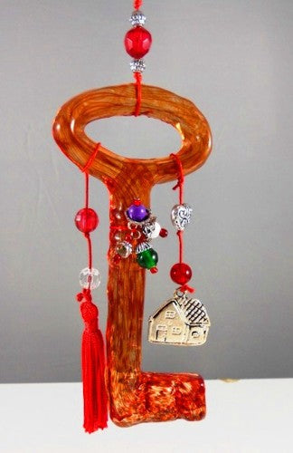 Vibrant red glass key with handmade trinkets, perfect for home decor and thoughtful gifts.