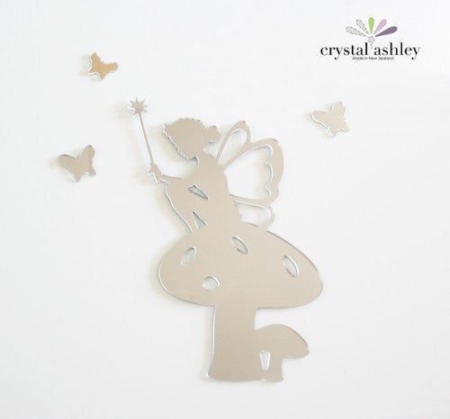 Tinkerbell perched on a toadstool surrounded by butterflies, crafted in mirror acrylic for whimsical wall décor.