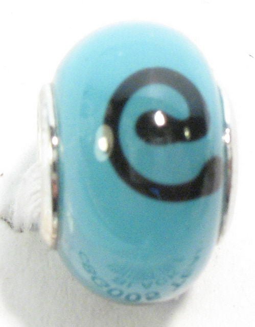 Teal and black handmade glass beads with Koru design, perfect for jewelry crafting and compatible with Pandora bracelets.