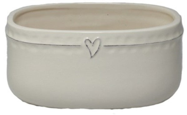 Off-white ceramic oval pot with heart design, perfect for small plants or as a charming home decor accent.