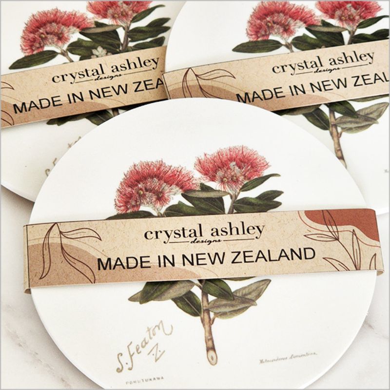 Vibrant Pohutukawa floral coaster featuring Sarah Featon’s artwork, made from durable acrylic with a cork base.