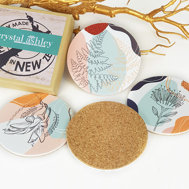 Colorful acrylic coasters with floral designs and cork backing, perfect for protecting surfaces and enhancing decor.