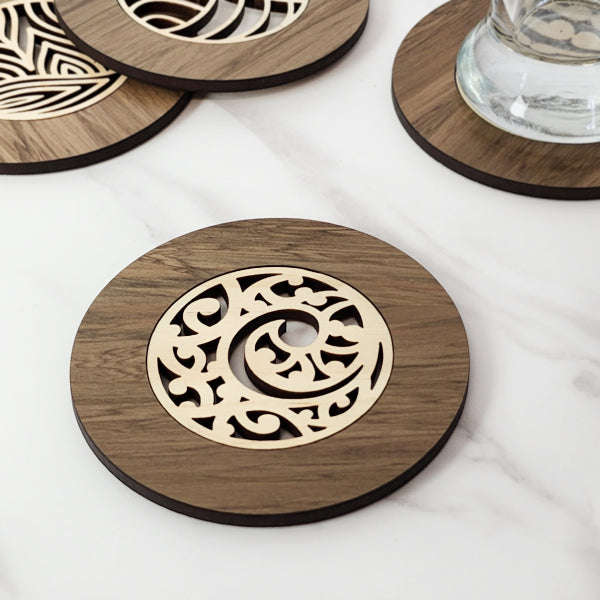 Single Kowhaiwhai Koru Coaster made from reclaimed New Zealand River Rimu, featuring unique colors and intricate inlay.