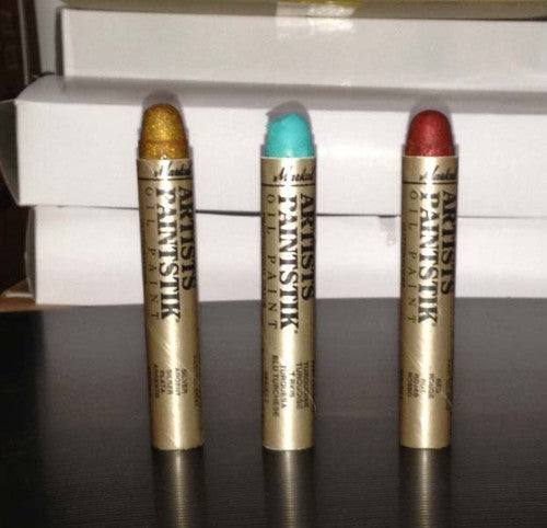 Turquoise glitter paint stick for vibrant, instant color on fabric, wood, and paper, ideal for artists and DIY projects.