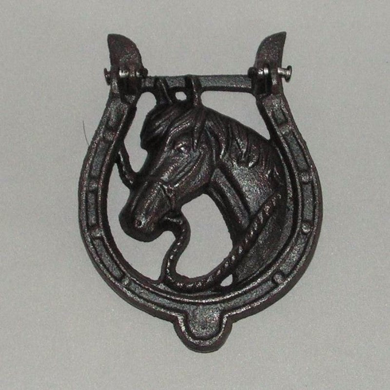 Rustic cast iron horse shoe door knocker, perfect for horse lovers, adds charm and good luck to any entrance.