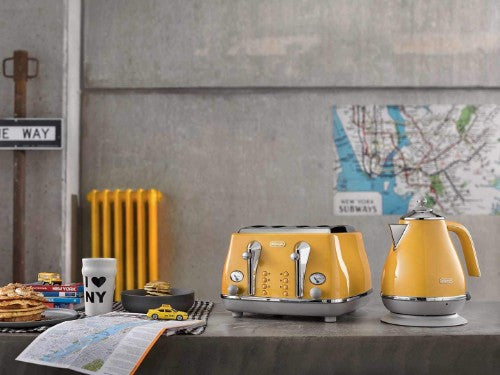 DeLonghi Icona Capitals Four Slice Toaster in vibrant New York Yellow, featuring wide slots, bagel button, and sleek stainless steel design.