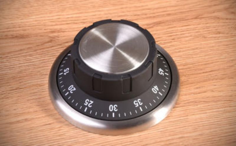 Sleek Safe Kitchen Timer resembling a combination lock, magnetically attaches to surfaces for easy access and precision cooking.
