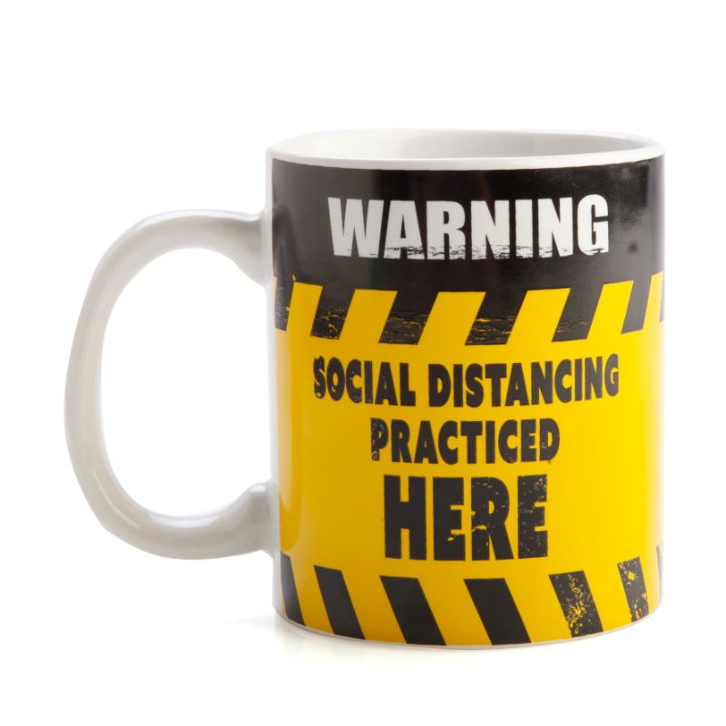 Ceramic coffee mug with a bold black and yellow social distancing warning sign design, perfect for home or office use.