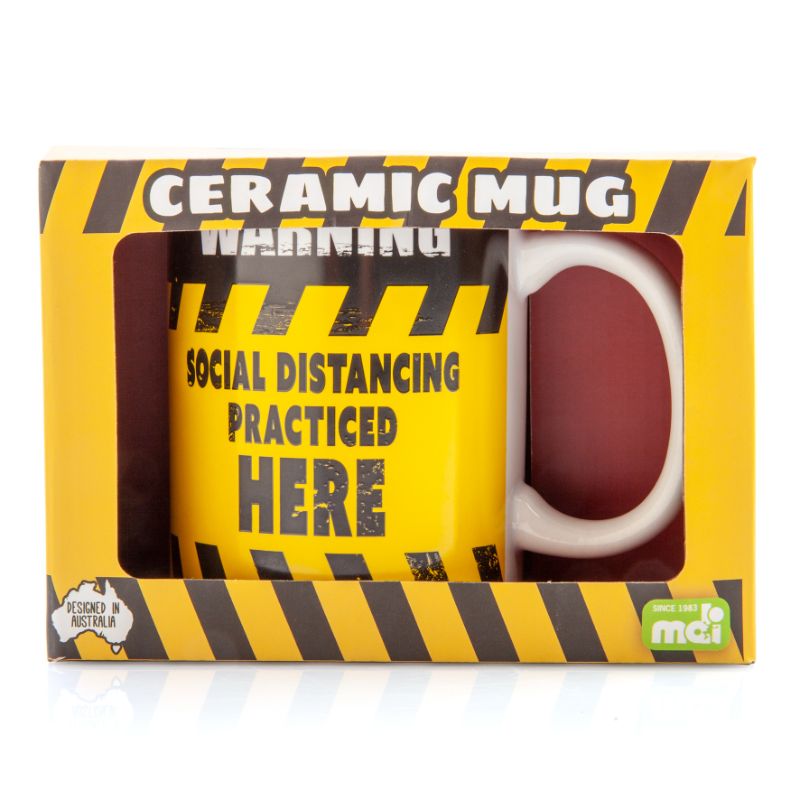 Ceramic coffee mug with a bold black and yellow social distancing warning sign design, perfect for home or office use.