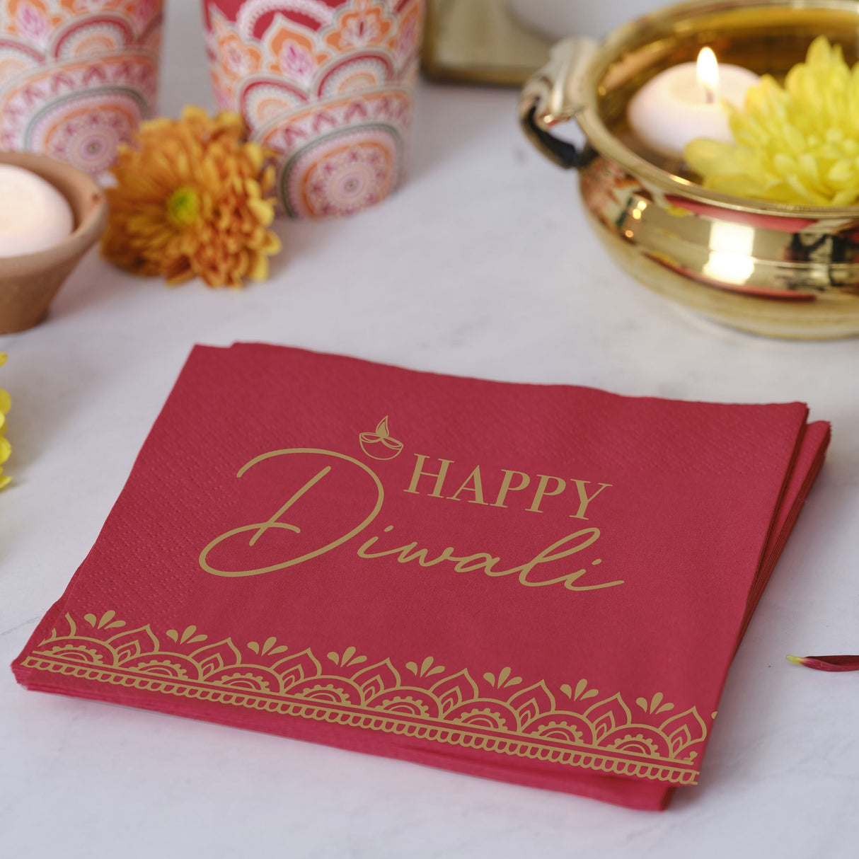 Vibrant red and gold Diwali beverage napkins with intricate patterns, ideal for festive gatherings and eco-friendly celebrations.