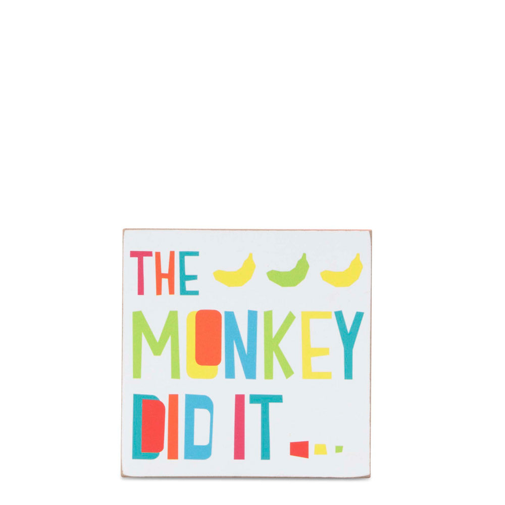Wooden block decor featuring the phrase "The Monkey Did It", perfect for home or office display.